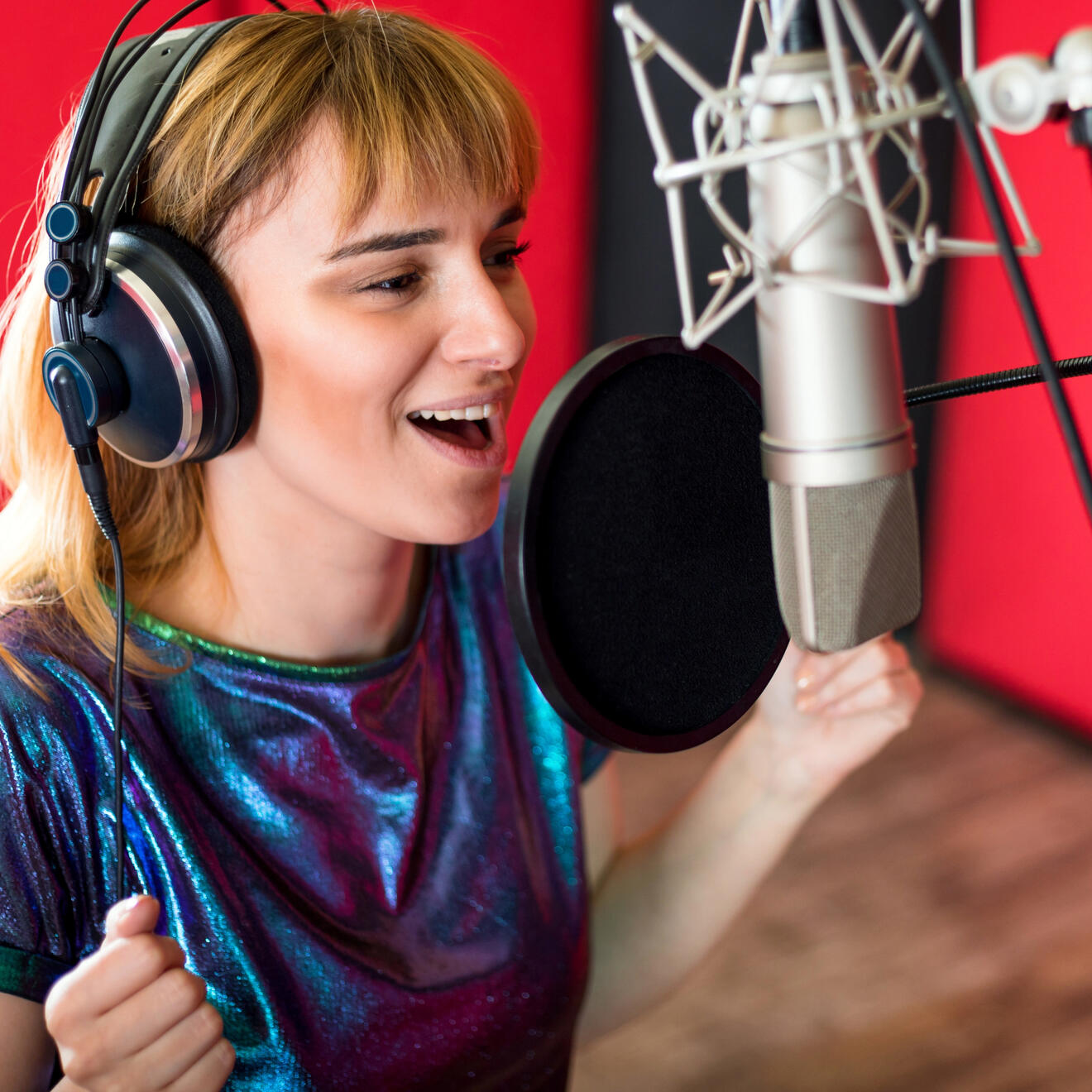Female Voiceover Artist Recording Professional Voiceover in Studio for Commercial and Media Projects Female voiceover artist recording professional voiceover audio in a studio for commercials, corporate video and media production